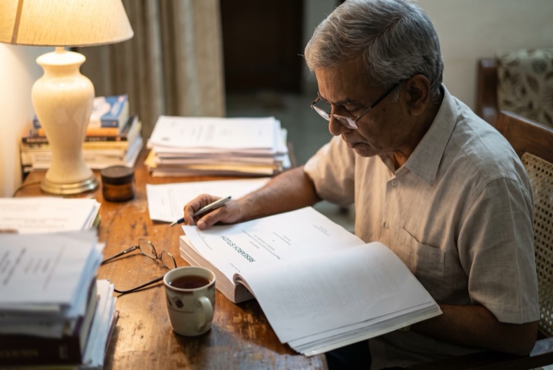 A man reading a research report at his desk