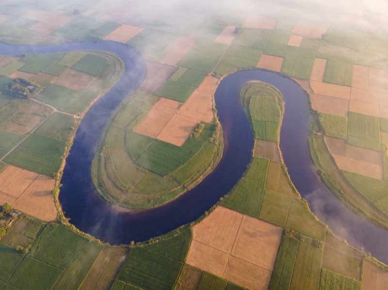 A river winding steadily through green fields